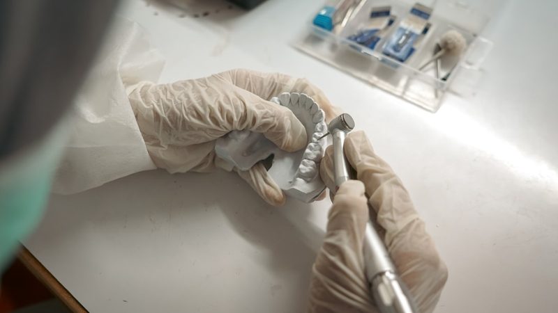 Gloved hands working at a lab bench